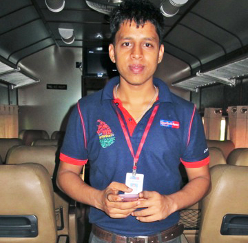 Dinesh, the Rajadhani carriage steward welcomes passengers